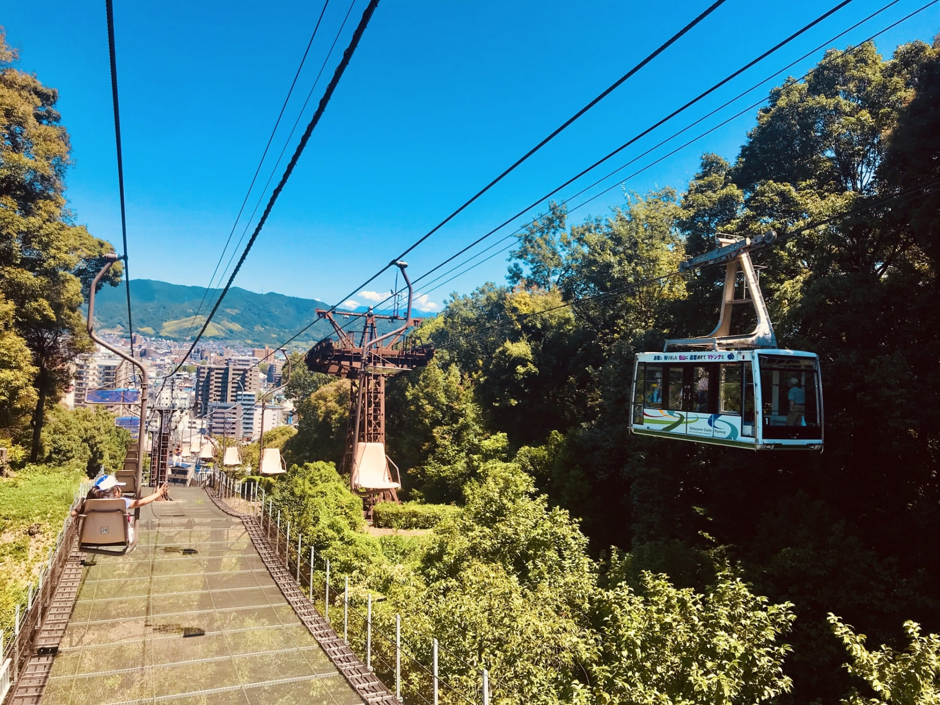 Matsuyama Castle ropeway gondola ascending the forested Mt. Katsuyama